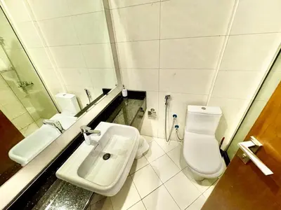 a bathroom with a sink and a toilet and a mirror at Perfect choice for a big family in Dubai