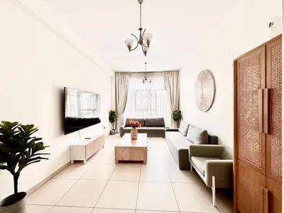 a living room with a couch and a tv at Perfect choice for a big family in Dubai