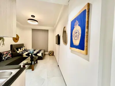 a living room with a couch and a table at Karama pretty unit near metro in Dubai