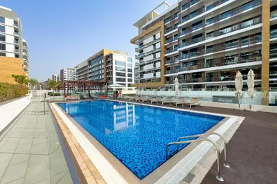 a swimming pool in the middle of a building at Stylish Studio with Gym & Pool in Azizi Riviera in Dubai