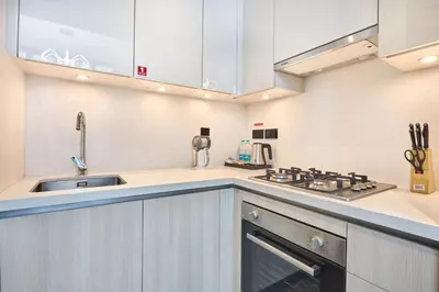 a kitchen with a sink and a stove at STAY BY LATINEM Luxury 1BR Holiday Home CC 1806 Near Burj Khalifa in Dubai