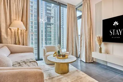 a living room with a couch and a table at STAY BY LATINEM Luxury 1BR Holiday Home CC 1806 Near Burj Khalifa in Dubai