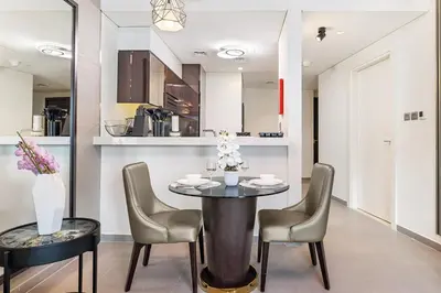 a dining room with a table and chairs at Beautiful Canal View Majestine Damac in Dubai