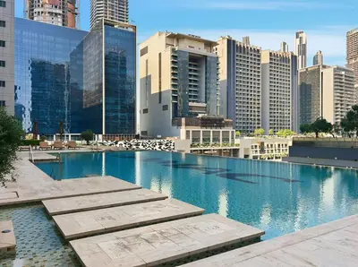 a swimming pool in a city with tall buildings at Beautiful Canal View Majestine Damac in Dubai