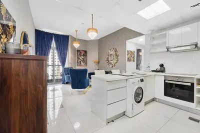 a white kitchen with a washer and dryer at Spacious 2 Bedroom Apartment in JBR in Dubai