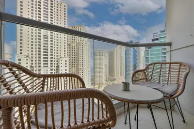 a balcony with two chairs and a table with a view at Spacious 2 Bedroom Apartment in JBR in Dubai