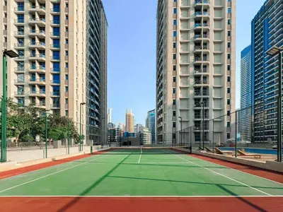 a tennis court in a city with tall buildings at Spacious 2 Bedroom Apartment in JBR in Dubai