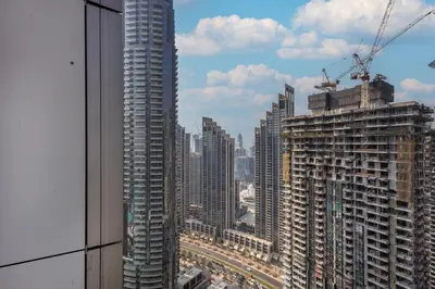 a view of a city skyline from a skyscraper at Grande Residence, Downtown - 1 Bedroom Apartment - Allsopp & Allsopp in Dubai