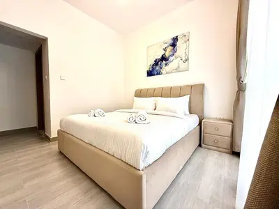 a bedroom with a bed with two towels on it at Majestic 2 BHK Park view at Liwan 2- Dubai in Dubai