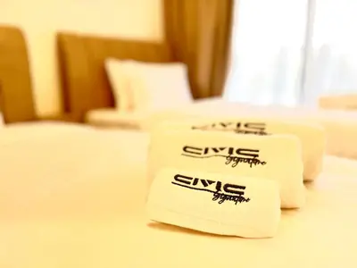 two towels on a bed in a hotel room at Majestic 2 BHK Park view at Liwan 2- Dubai in Dubai