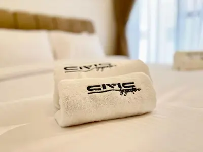 a towel sitting on top of a bed at Majestic 2 BHK Park view at Liwan 2- Dubai in Dubai