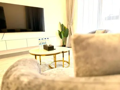 a living room with a couch and a table at Majestic 2 BHK Park view at Liwan 2- Dubai in Dubai