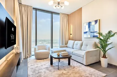 a living room with a couch and a table at STAY BY LATINEM Luxury 1BR Holiday Home CB 2601 Near Burj Khalifa in Dubai