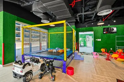 a childrens play room with a ping pong net at Modern Luxury 2BR Apartment In Dubai Sports City in Dubai