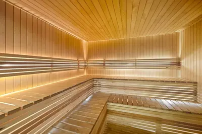 a large empty sauna with wooden walls and ceilings at Modern Luxury 2BR Apartment In Dubai Sports City in Dubai