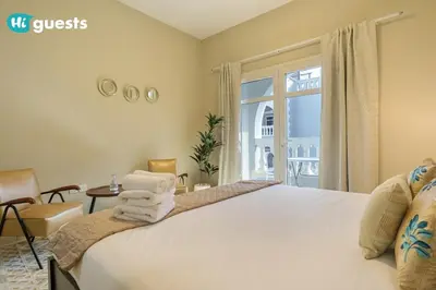 a bedroom with a large white bed with a window at HiGuests - Experience Luxury 1BR Living at Autumn-1A in JVC in Dubai