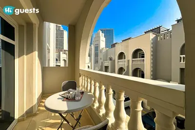 a balcony with a table and a view of the city at HiGuests - Experience Luxury 1BR Living at Autumn-1A in JVC in Dubai