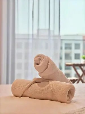 a towel shaped like an elephant sitting on a table at Stylish New Studio Apartment with Balcony in Dubai