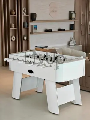 a white foosball table in a living room at Stylish New Studio Apartment with Balcony in Dubai