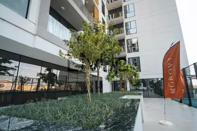 a tree in the middle of a building at Stylish 1-Bedroom in JVC with large balcony in Dubai