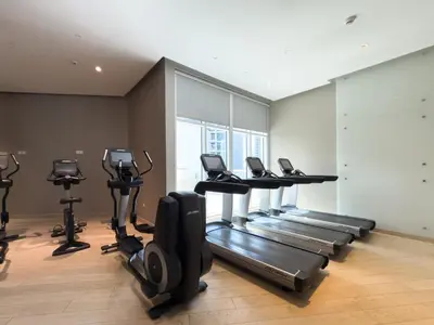 a gym with treadmills and elliptical machines at GuestReady - Studio l Canal Views | Business Bay in Dubai