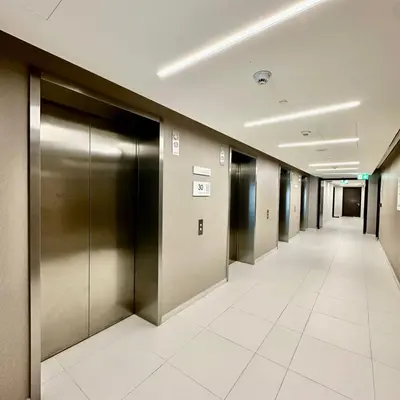 a hallway with silver elevators in a building at Boulevard Heights Downtown Perfect Location High floor Luxury Apartment! in Dubai