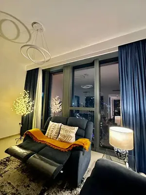 a living room with a couch and a large window at Boulevard Heights Downtown Perfect Location High floor Luxury Apartment! in Dubai