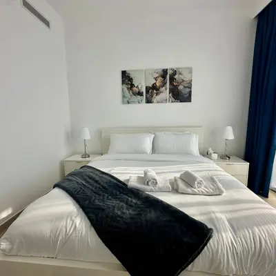 a bedroom with a large white bed with three pillows at Boulevard Heights Downtown Perfect Location High floor Luxury Apartment! in Dubai
