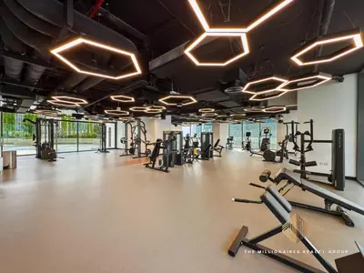 a gym with several tread machines and lights at Burj Khalif View from Bedroom - Millionaire Residence in Business Bay Dubai in Dubai