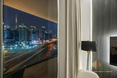 a room with a window with a view of a city at Burj Khalif View from Bedroom - Millionaire Residence in Business Bay Dubai in Dubai
