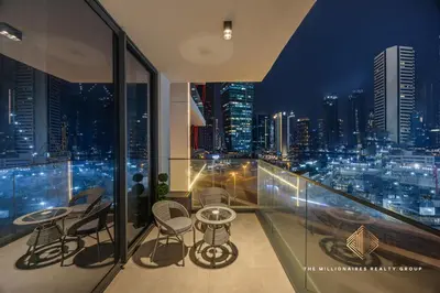 a balcony with a view of a city at night at Burj Khalif View from Bedroom - Millionaire Residence in Business Bay Dubai in Dubai