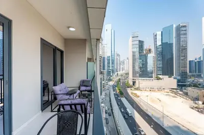a balcony with chairs and a view of a city at GuestReady - 1BR l Canal View | Business Bay in Dubai