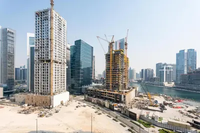 a group of tall buildings in a city at GuestReady - 1BR l Canal View | Business Bay in Dubai