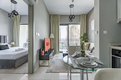 a living room with a bed and a glass table at GuestReady - 1BR l Canal View | Business Bay in Dubai