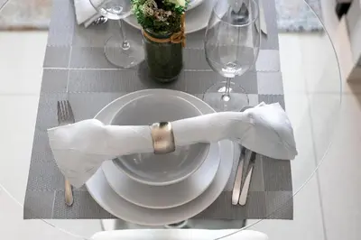 a table with a plate with a napkin on it at GuestReady - 1BR l Canal View | Business Bay in Dubai