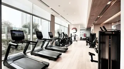 a gym with a bunch of treadmills and machines at Vida Residence Dubai Mall by Propigo in Dubai