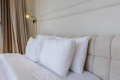 a bedroom with white pillows on a couch at Skyview Luxe 4BR - Elegant Sea & Ain Dubai View in Dubai