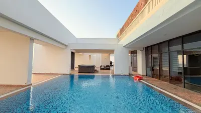 a swimming pool in the middle of a building at Sleek 1BR Apt Free Pool & Gym Access in Dubai