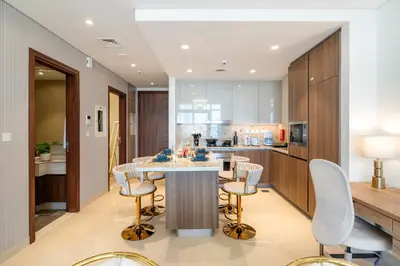 a kitchen with a table and chairs and a counter at Classy and Chic 2BR in Downtown with Burj Khalifa View in Dubai