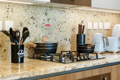 a kitchen counter with pots and pans on a stove at Classy and Chic 2BR in Downtown with Burj Khalifa View in Dubai
