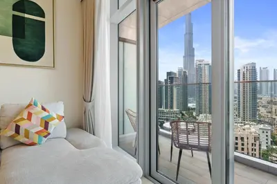 a living room with a couch and a large window at Classy and Chic 2BR in Downtown with Burj Khalifa View in Dubai