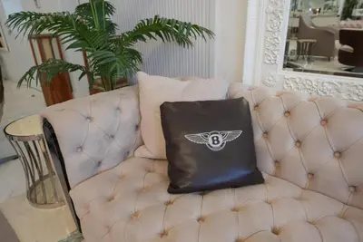 a leather bag sitting on a chair in a living room at World Class Luxurious 5 BDR Villa In Palm Jumeriah in Dubai