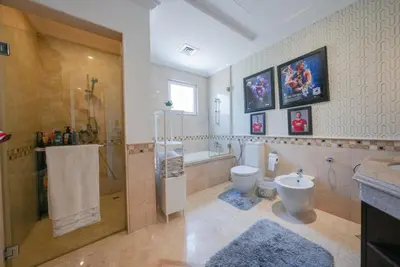 a bathroom with a shower and a toilet and a sink at World Class Luxurious 5 BDR Villa In Palm Jumeriah in Dubai