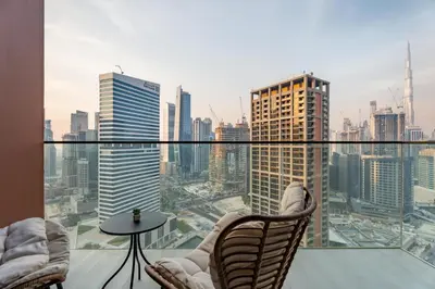 a balcony with chairs and a view of a city at GuestReady - Studio | Canal View & Burj Khalifa in Dubai