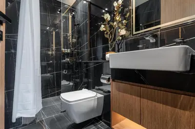 a bathroom with a white toilet and a sink at GuestReady - Luxury with a Private Pool | 2 BHK in Dubai