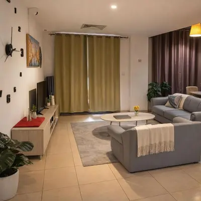 a living room with a couch and a table at Dubai Beach Living JBR Hostel in Dubai