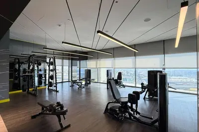 a gym with treadmills and cardio equipment in a building at Cozy 2BR Aykon City Near Downtown - Pool and Gym in Dubai