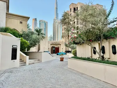 a cobblestone street in a city with tall buildings at Downtown close to Dubai mall in Dubai