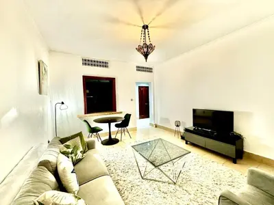 a living room with a couch and a table at Downtown close to Dubai mall in Dubai