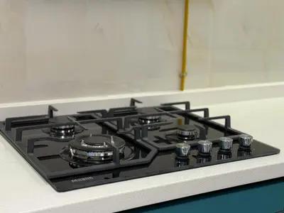 a stove top oven sitting on top of a kitchen counter at Studio and One bedroom in Danube Opalz by The S Holiday Homes in Dubai
